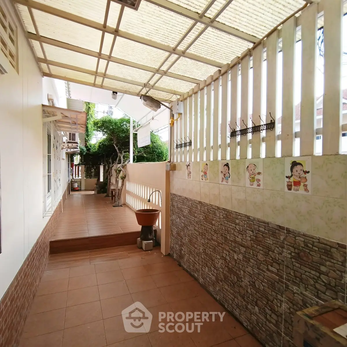 Charming covered walkway with decorative tiles and natural light