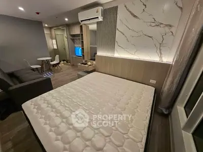 Modern bedroom with stylish decor and cozy ambiance, featuring a comfortable bed and elegant lighting.