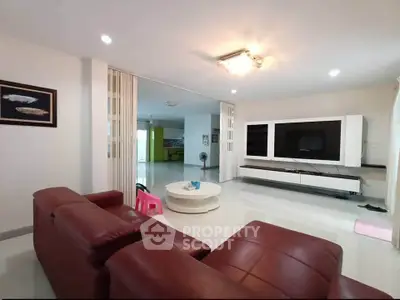 Spacious modern living room with sleek furniture and entertainment center
