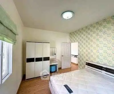 Spacious bedroom with modern decor and ample natural light