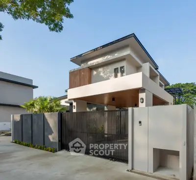 Modern luxury home exterior with sleek design and spacious driveway.