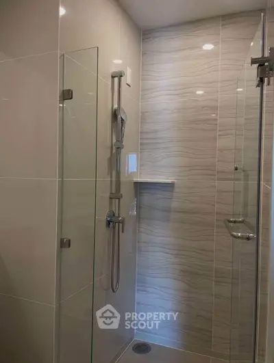 Modern bathroom shower with sleek glass doors and elegant tile design
