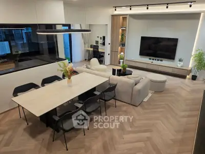 Modern open-plan living room with stylish dining area and sleek furniture