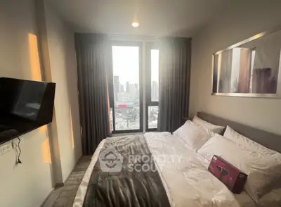 Modern bedroom with city view, featuring a wall-mounted TV and elegant decor.