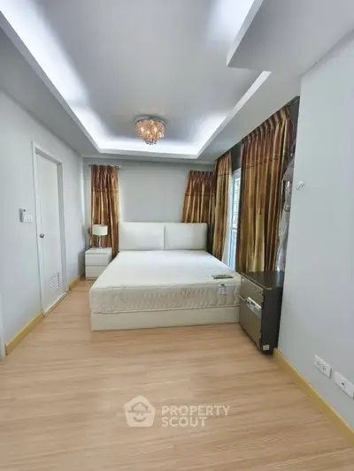 Spacious bedroom with elegant lighting and modern decor