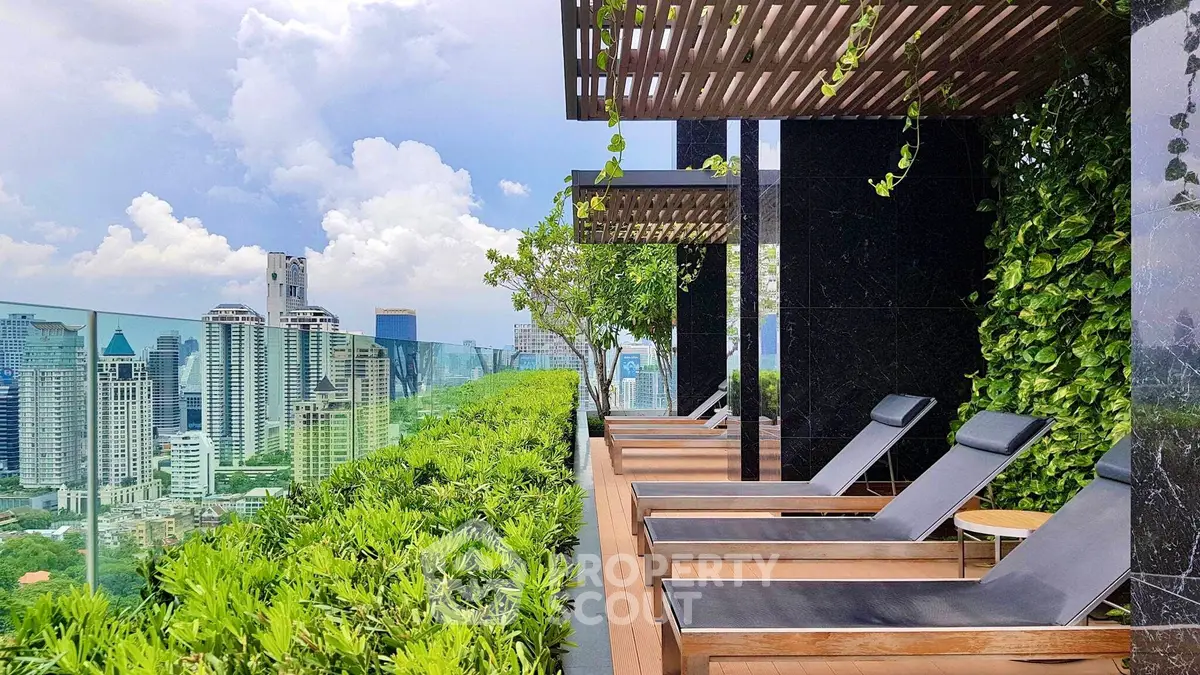 Luxurious rooftop terrace with stunning city skyline view and modern lounge chairs.