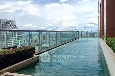 Luxurious rooftop pool with stunning city skyline views in modern high-rise building.