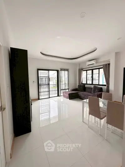 Spacious modern living room with sleek design and abundant natural light.