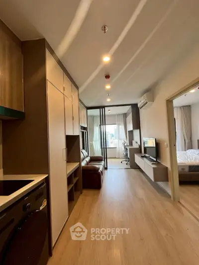 Modern apartment interior with open layout, featuring a cozy living area and stylish kitchen.