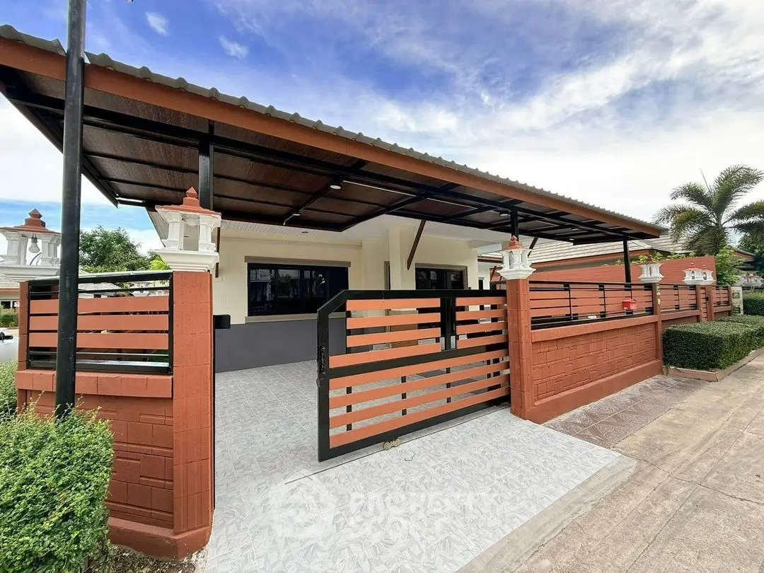 Charming single-story home with modern gated entrance and spacious driveway.