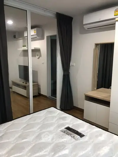 Modern bedroom with air conditioning and sliding glass doors in a stylish apartment.