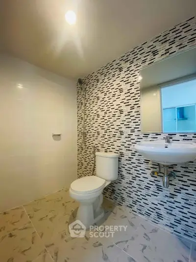Modern bathroom with stylish tile design and sleek fixtures