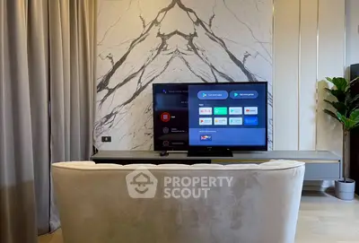 Modern living room with elegant marble accent wall and smart TV setup.