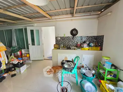 Spacious kitchen area with open layout and ample storage space, featuring modern appliances and tiled backsplash.