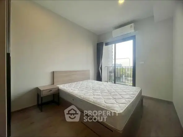 Modern bedroom with balcony access and natural light