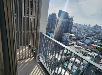 Stunning city view from high-rise balcony with modern railing design.