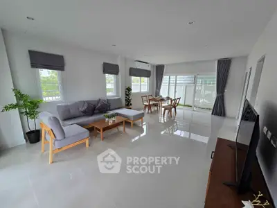 Spacious modern living room with elegant decor and large windows