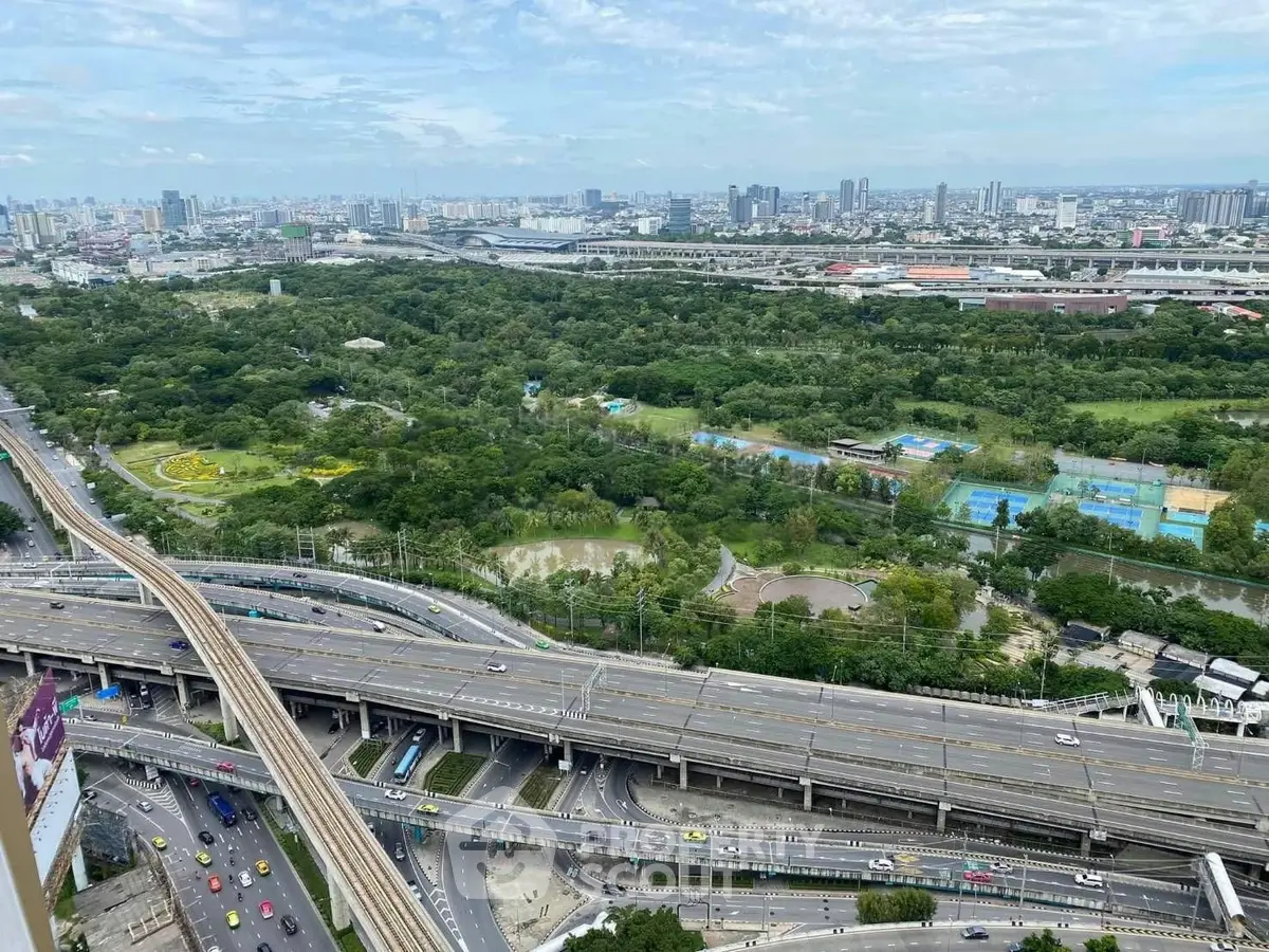 Stunning aerial view of urban landscape with lush greenery and highway, perfect for city living enthusiasts.