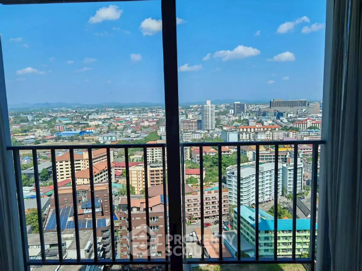 Stunning high-rise balcony view showcasing vibrant cityscape under clear blue skies.
