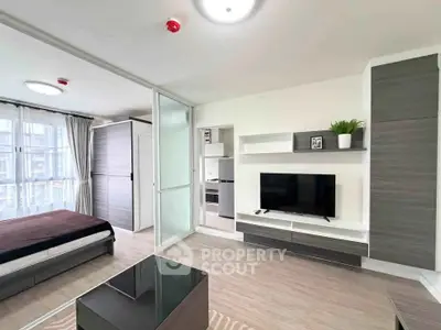 Modern studio apartment with open layout, featuring sleek furniture and natural light.