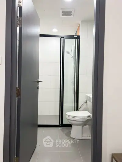 Modern bathroom with sleek shower enclosure and contemporary fixtures.