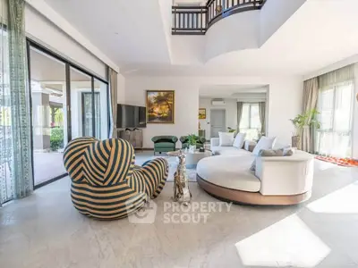 Luxurious modern living room with stylish furniture and large windows offering abundant natural light.