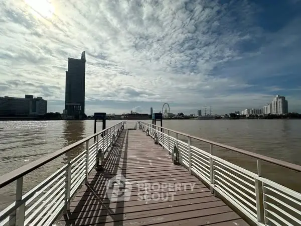Stunning riverside view with modern skyline and boardwalk, perfect for urban waterfront living.