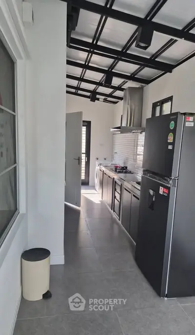 Modern kitchen with sleek appliances and open layout in contemporary home