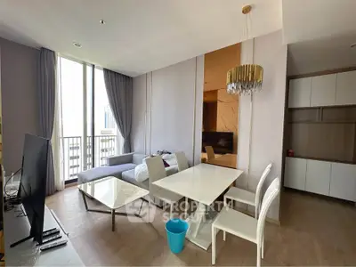 Modern living room with dining area and large windows in a stylish apartment.