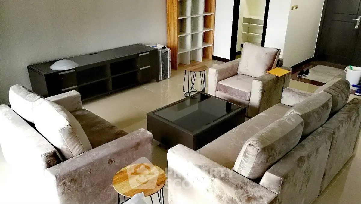 Spacious living room with modern furniture and sleek design, perfect for relaxation and entertainment.