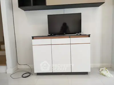 Modern living room with sleek TV cabinet and mounted television