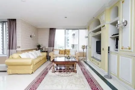 Elegant living room with classic decor, featuring a spacious layout and large windows for natural light.