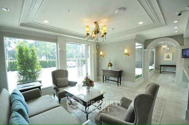 Elegant living room with plush seating and large windows offering natural light.