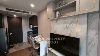 Modern living room with sleek TV setup and elegant dining area