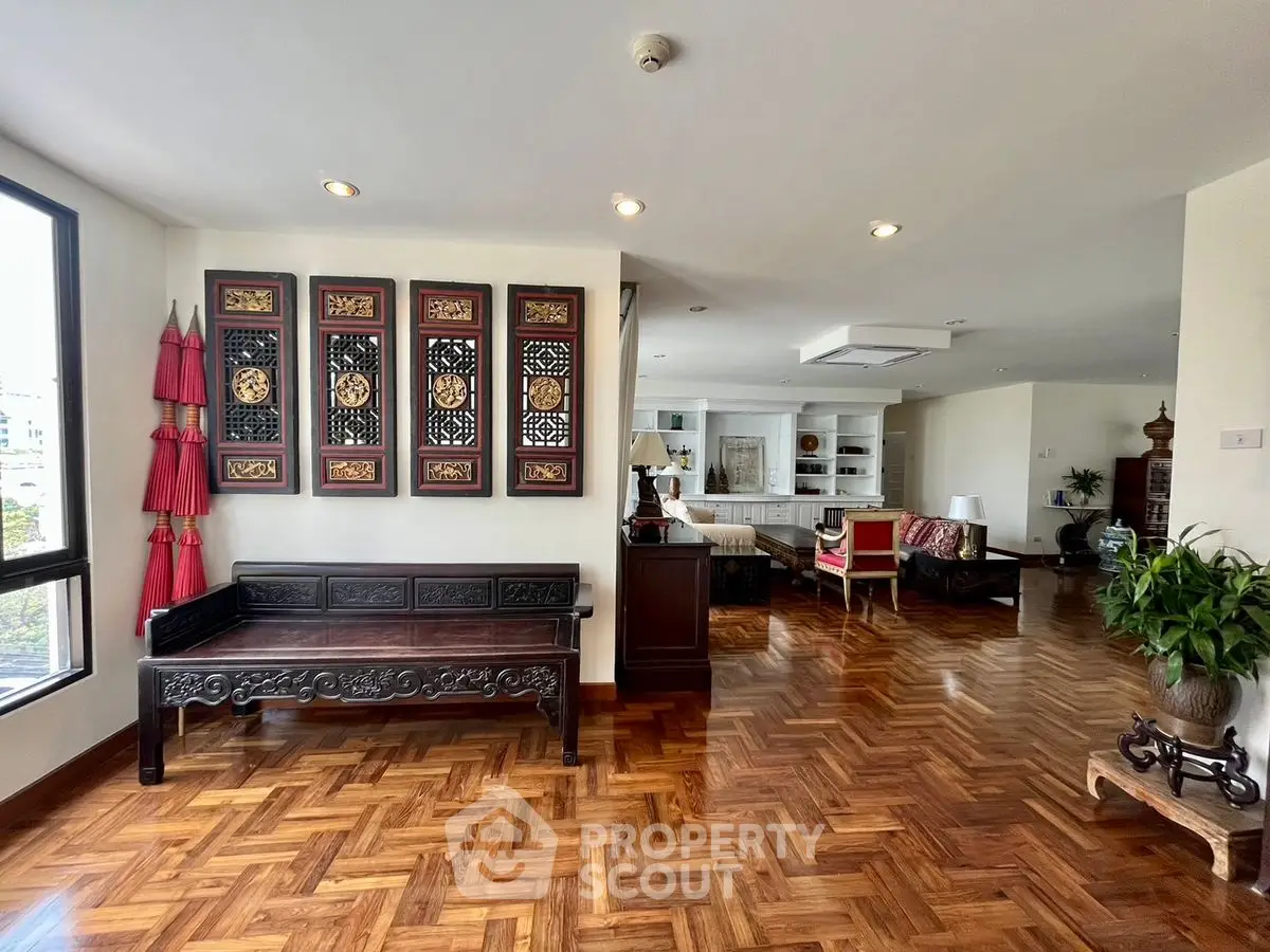 Spacious living room with elegant wooden flooring and traditional decor
