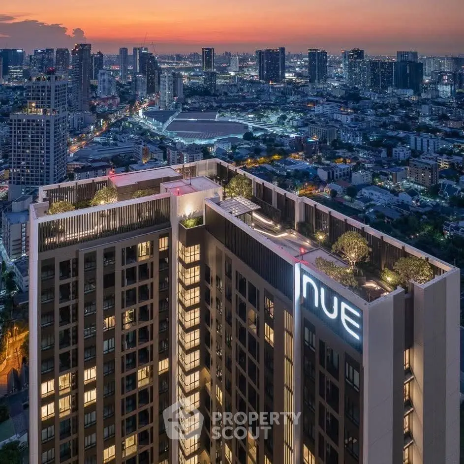 Stunning cityscape view from high-rise building rooftop at sunset.