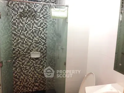 Modern bathroom with glass shower and mosaic tile design