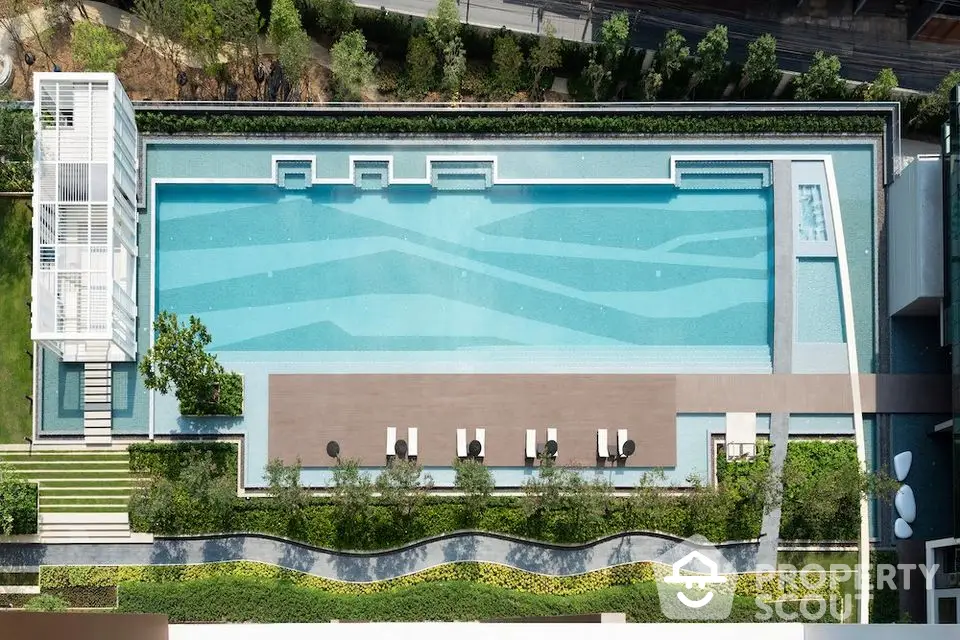 Luxurious rooftop pool with modern design and lush greenery, perfect for relaxation and leisure.