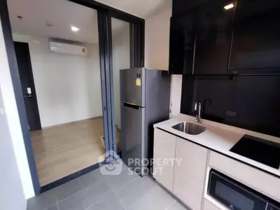 Modern kitchen with sleek appliances and open layout in a stylish apartment.