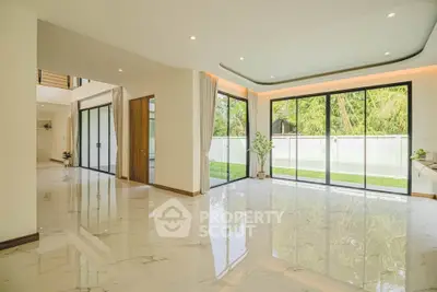 Spacious modern living room with large windows and garden view