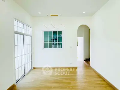 Bright and spacious living room with modern lighting and large windows