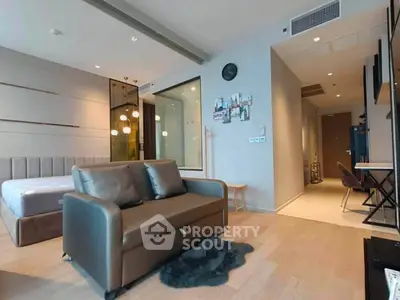 Modern studio apartment with stylish decor and open layout, featuring a cozy living area and comfortable bed.