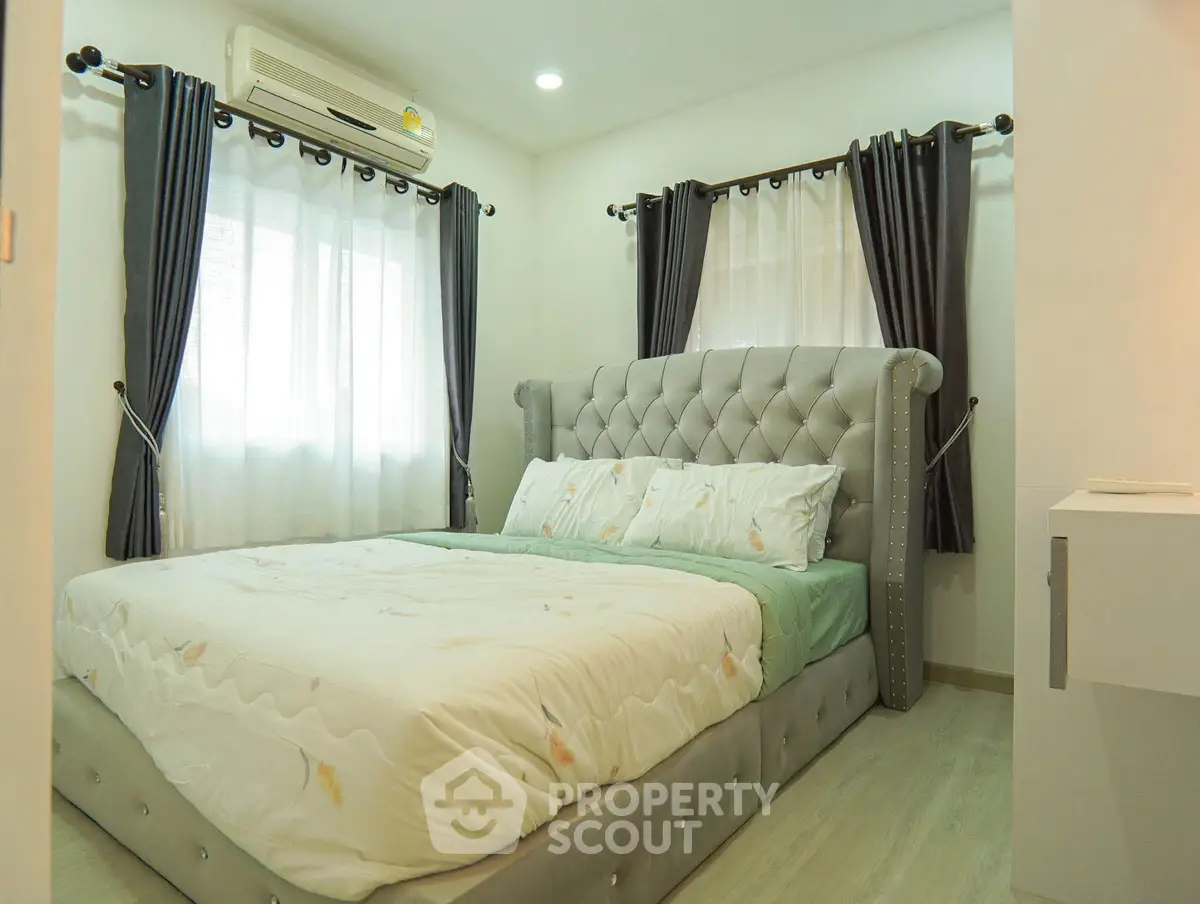 Cozy bedroom with elegant tufted headboard and natural light