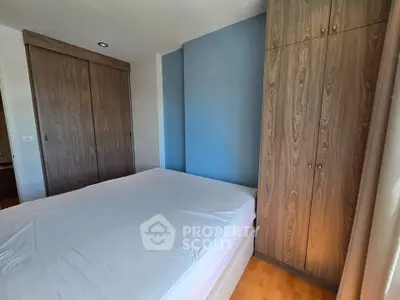Spacious bedroom with wooden wardrobes and natural light