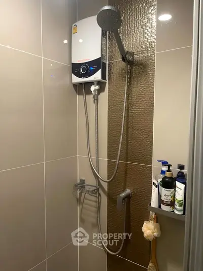 Modern bathroom shower area with sleek design and water heater