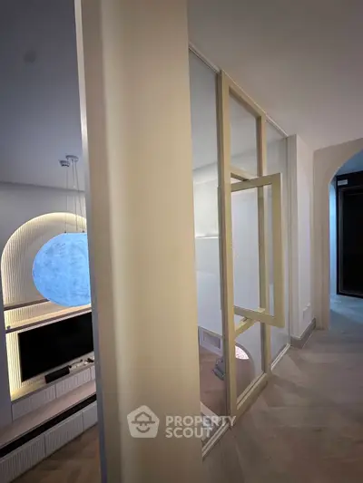 Modern living room with stylish decor and unique lighting feature
