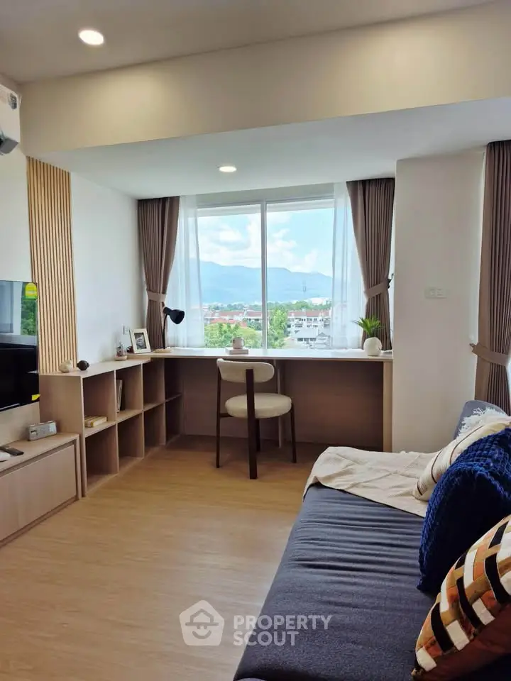 Modern living room with mountain view, featuring stylish decor and natural light.