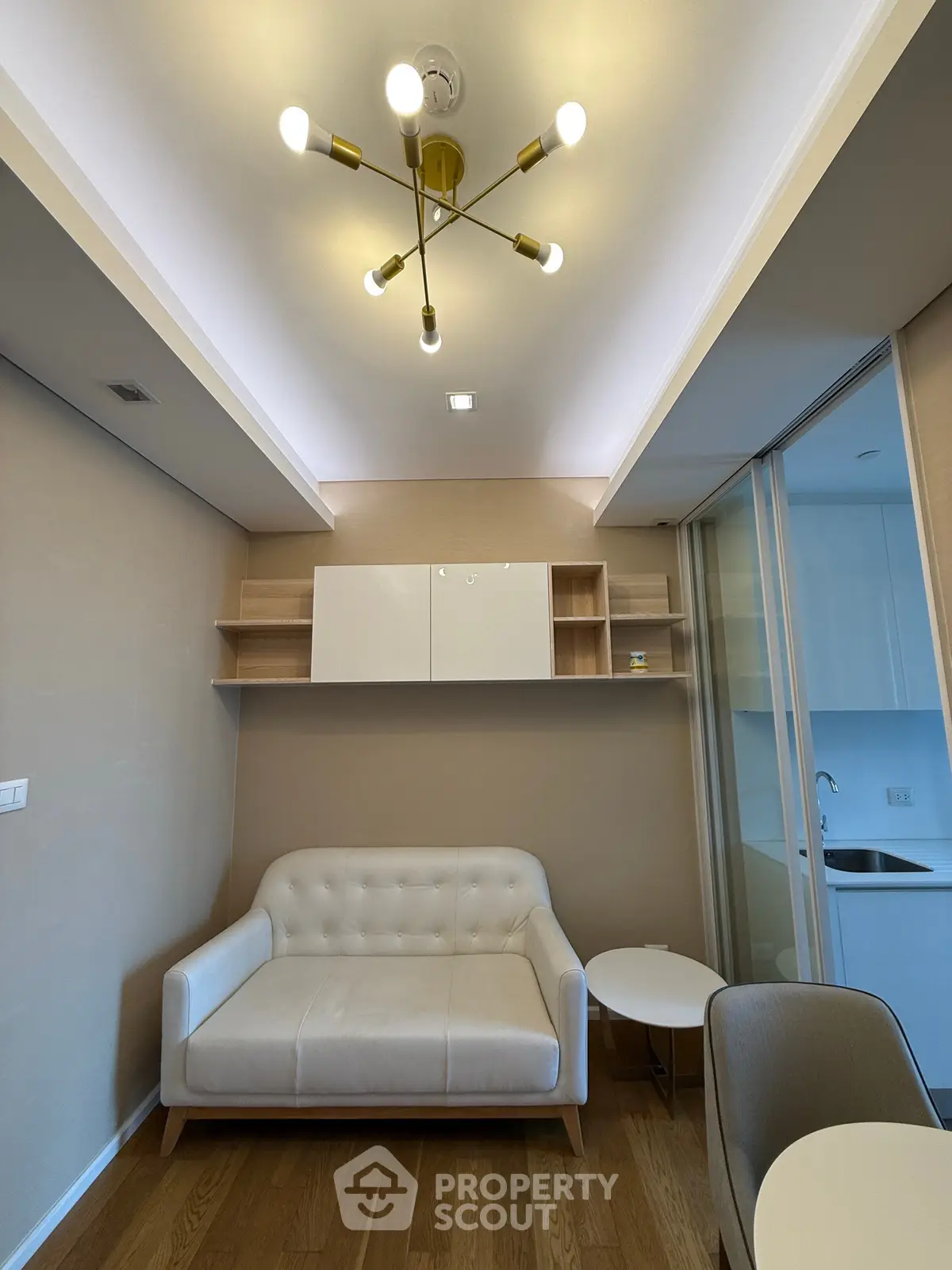 Modern living room with stylish lighting and cozy seating in a contemporary apartment.