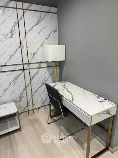 Modern study area with marble desk and sleek chair in stylish home office.