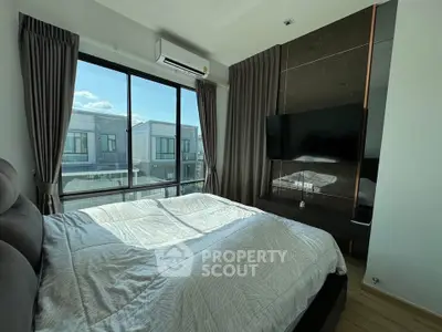 Modern bedroom with large window and stylish decor in a contemporary home.